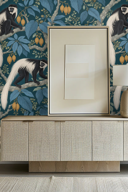 Bathroom scene with Moonstone Monkey Boughs wallpaper behind marble and gold towel ring