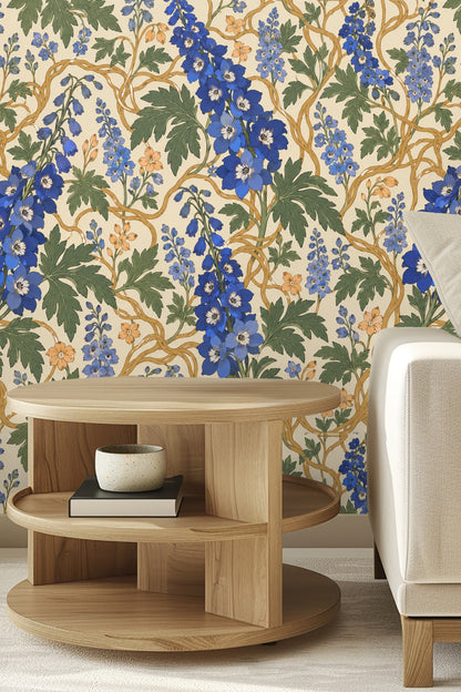 Room with green bed featuring wallpaper with blue delphinium flowers and golden vines on cream backdrop