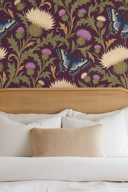 Living room with orange sofa and vintage rug featuring a wall covered in Thistle & Swallowtail wallpaper