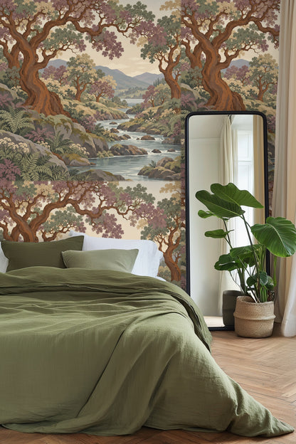 Living room with wallpaper featuring copper-barked trees over a serene stream, paired with neutral sofa and green velvet stool.