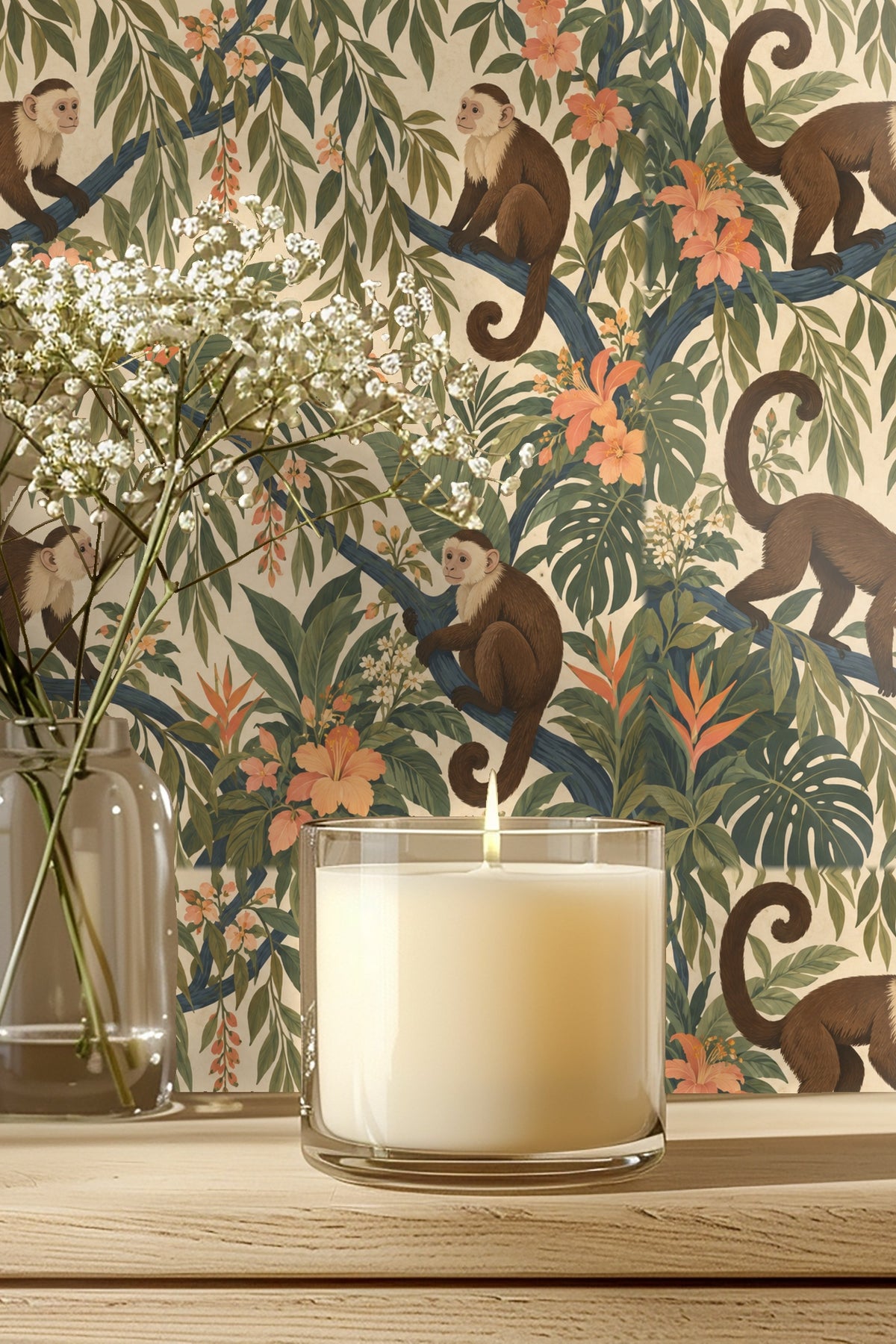 Detailed close-up of wallpaper showing brown capuchin monkeys perched on blue branches among green leaves and peach flowers