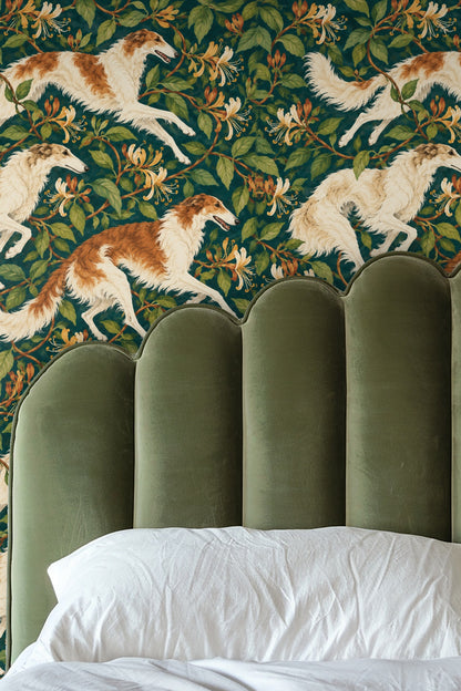 Leather armchair and marble side table beside wall with rich teal wallpaper featuring playful sighthound and honeysuckle floral motif