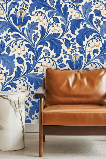 Golden retriever resting on grey dog bed with cobalt blue and white floral wallpaper behind