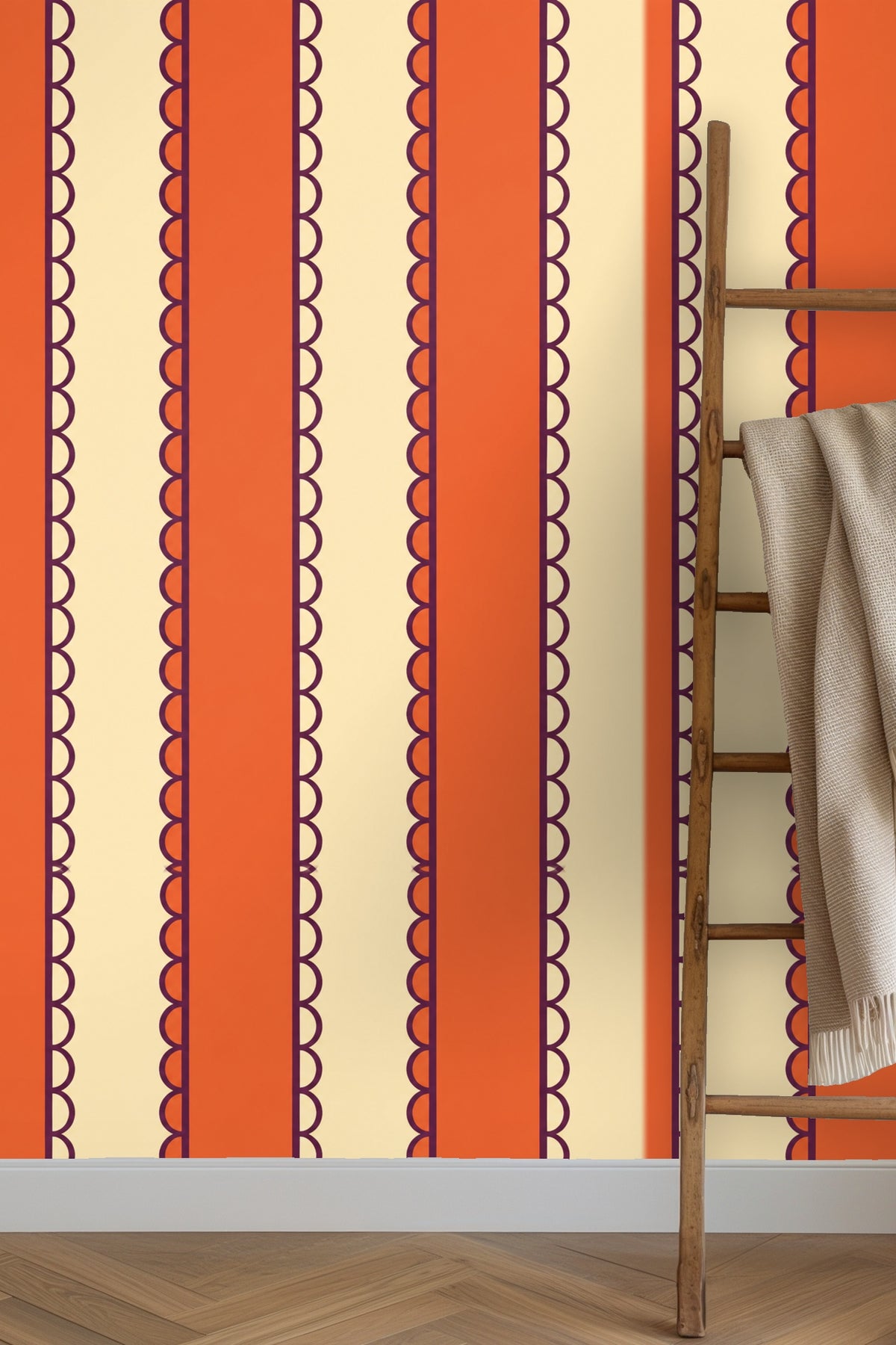 Living room with blue velvet couch against wall covered in Persimmon Pavilion Stripe wallpaper