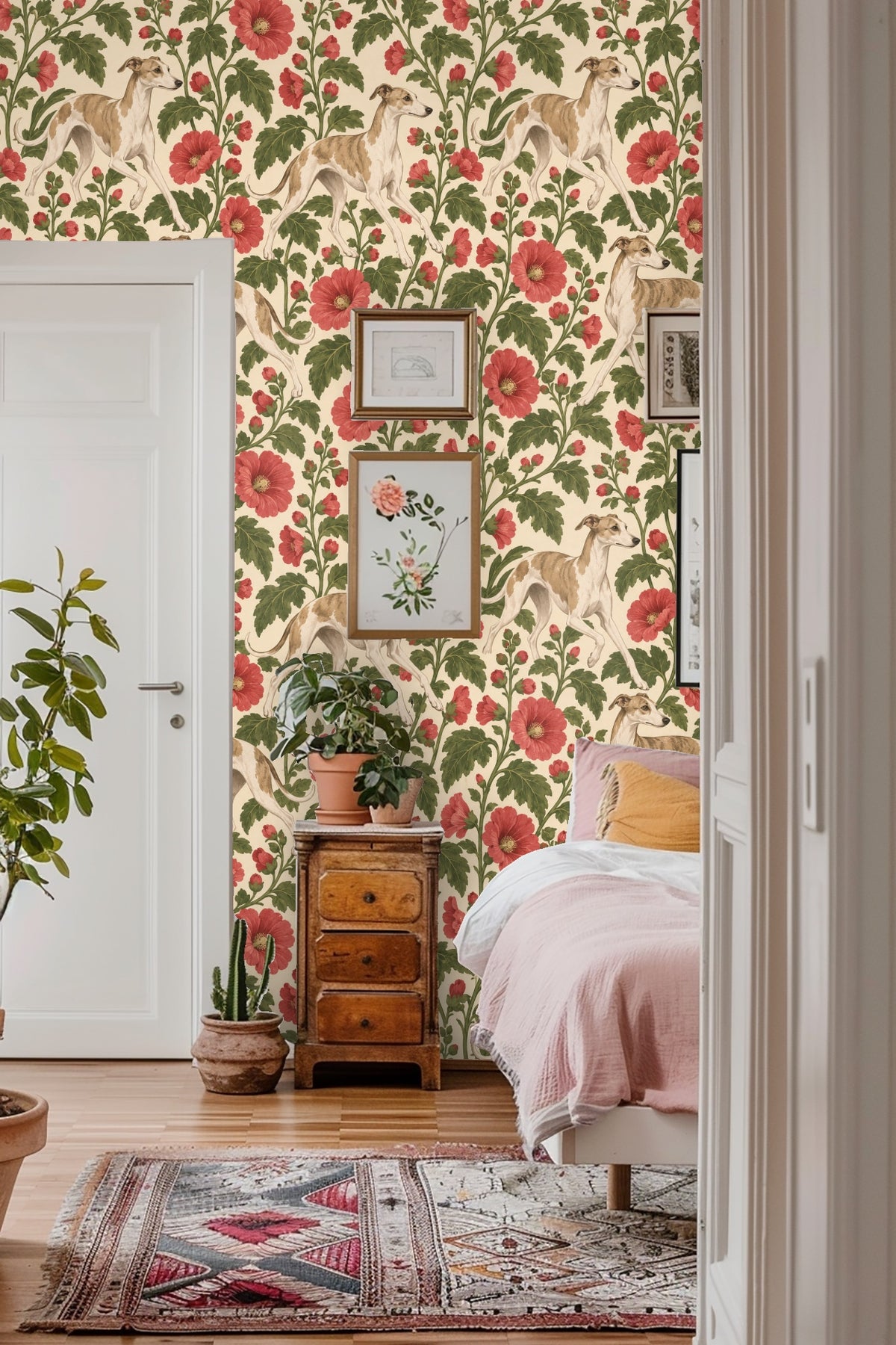 Detailed view of wallpaper showing tan and white greyhounds walking among tall red hollyhock flowers and green leaves on cream background