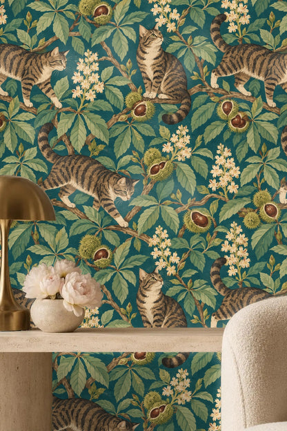 Three tabby cats at varying poses among sprawling chestnut branches and botanical foliage on wallpaper