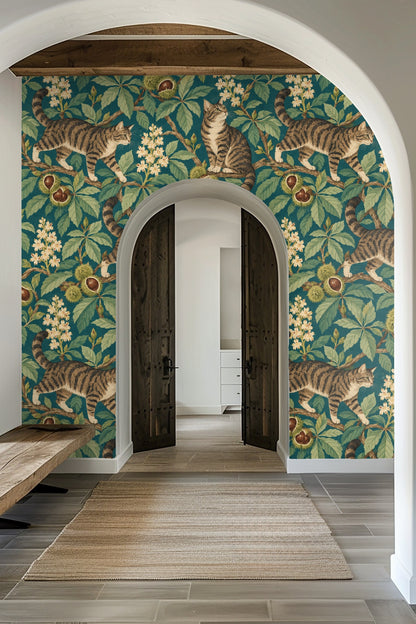 Laundry room with Chestnut Park Cats wallpaper showing tabby cats on chestnut branches, blending with wood shelves and white towels