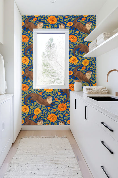 Otters standing and stretching amid lush marigold-toned floral branches on wallpaper