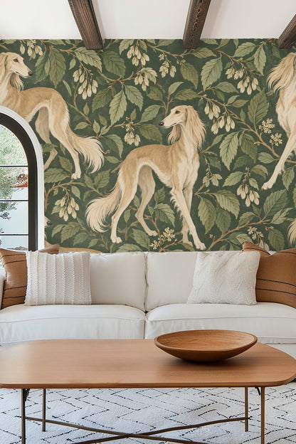 Bedroom interior with green scalloped headboard in front of a wallpapered wall featuring golden Saluki dogs and leafy branches