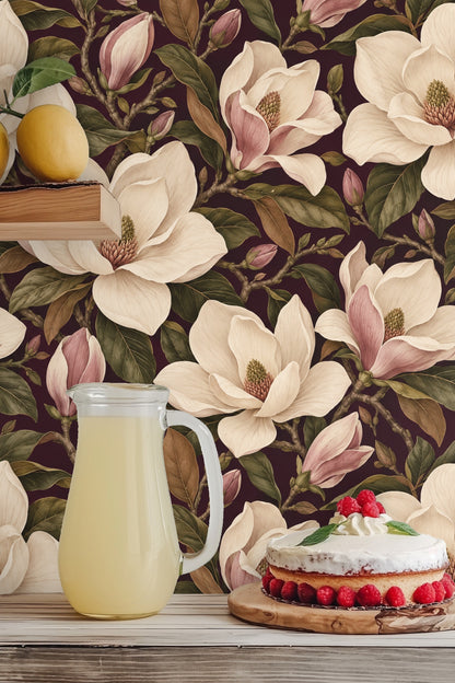 Magnolia buds and flowers arranged in an elegant floral pattern on rich plum