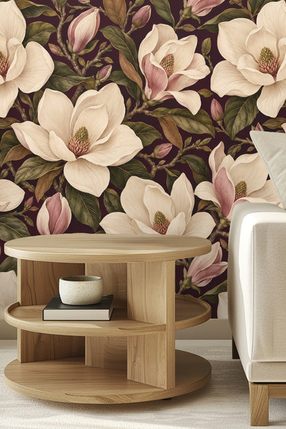 Close-up showing soft cream petals and pink-tinged magnolia buds against deep plum