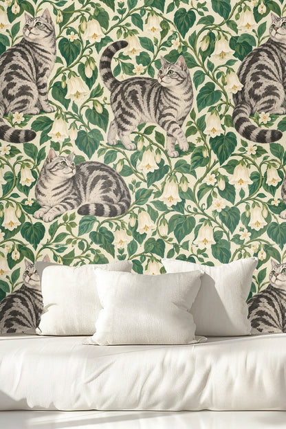 Pattern repeat overview of wallpaper showing multiple tabby cats surrounded by leafy vines and bell-shaped flowers.