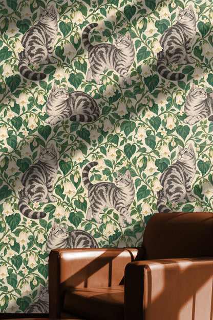 Room setting showing natural light illuminating wallpaper with tabby cat motif and white flowering vines.