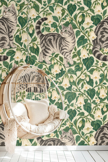 Bedroom wall decorated with Bellvine Cat Tangle wallpaper, featuring tabby cats and floral pattern behind green bedding.
