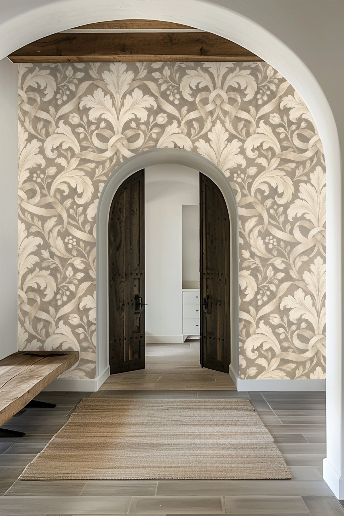 Living room scene with Pearl Leaf Cartouche wallpaper behind a leather chair and marble side table, highlighting scale and mood