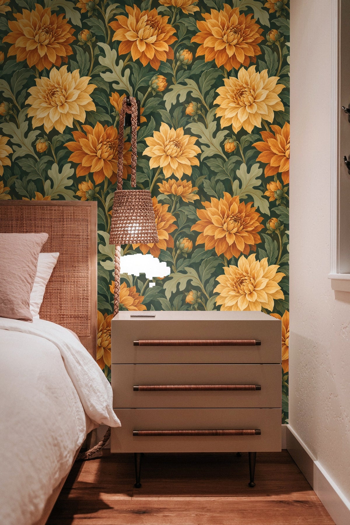 Detailed view of overlapping orange and yellow dahlia blossoms with textured painterly leaves.