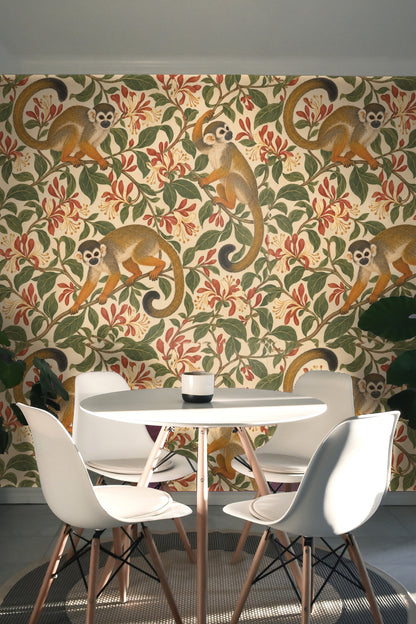 Installation view highlighting warm tones of monkeys against lush greenery in a living room setting