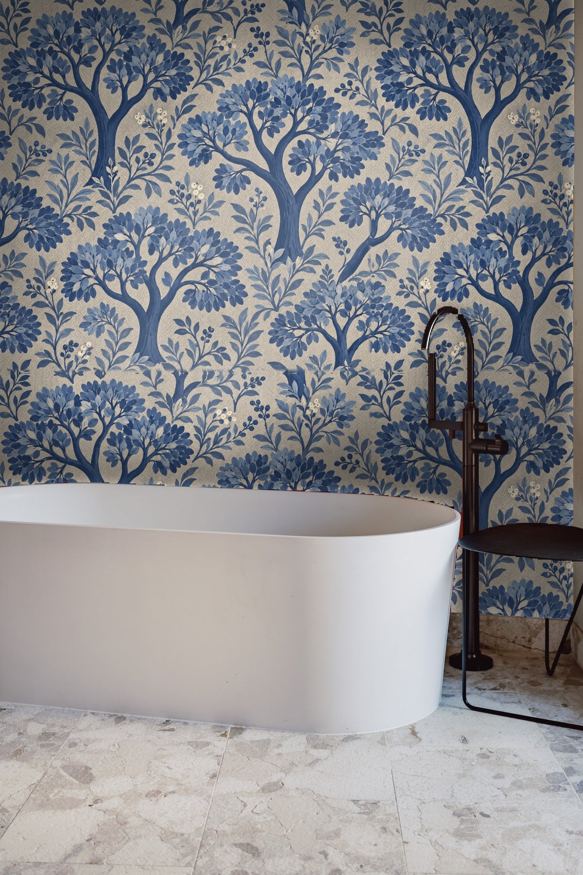 Full wall view inside a living room featuring blue botanical wallpaper behind sofa