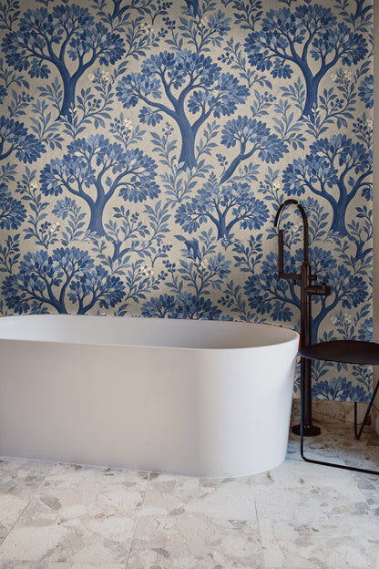 Full wall view inside a living room featuring blue botanical wallpaper behind sofa