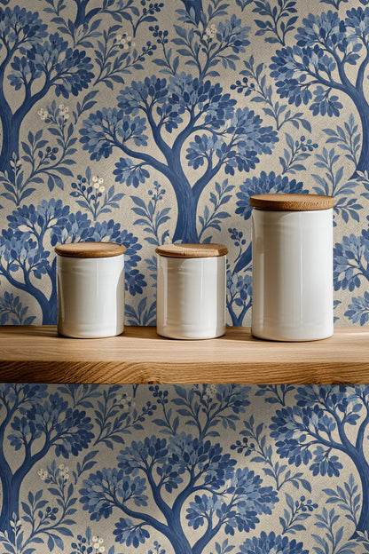 Leafy branches spreading around stylized tree trunks in blue hues on textured wallpaper
