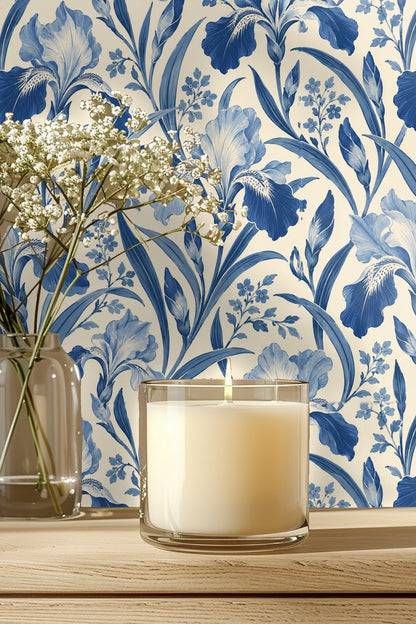 Close-up of wallpaper showing deep blue and pale blue iris flowers on cream background