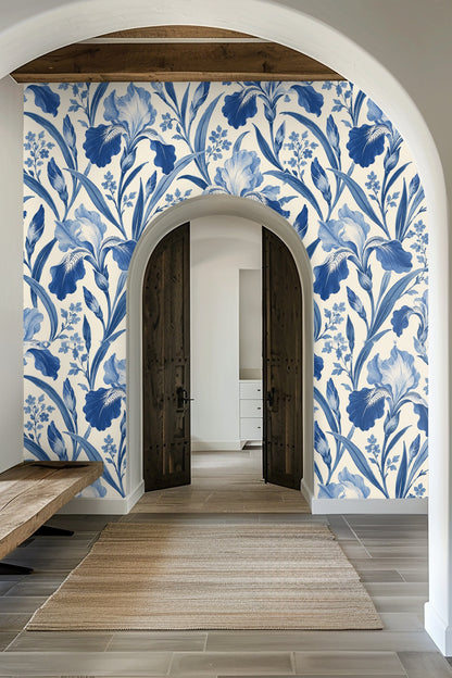Arched entryway with Porcelain Iris wallpaper in classic blue tones framing wooden double doors