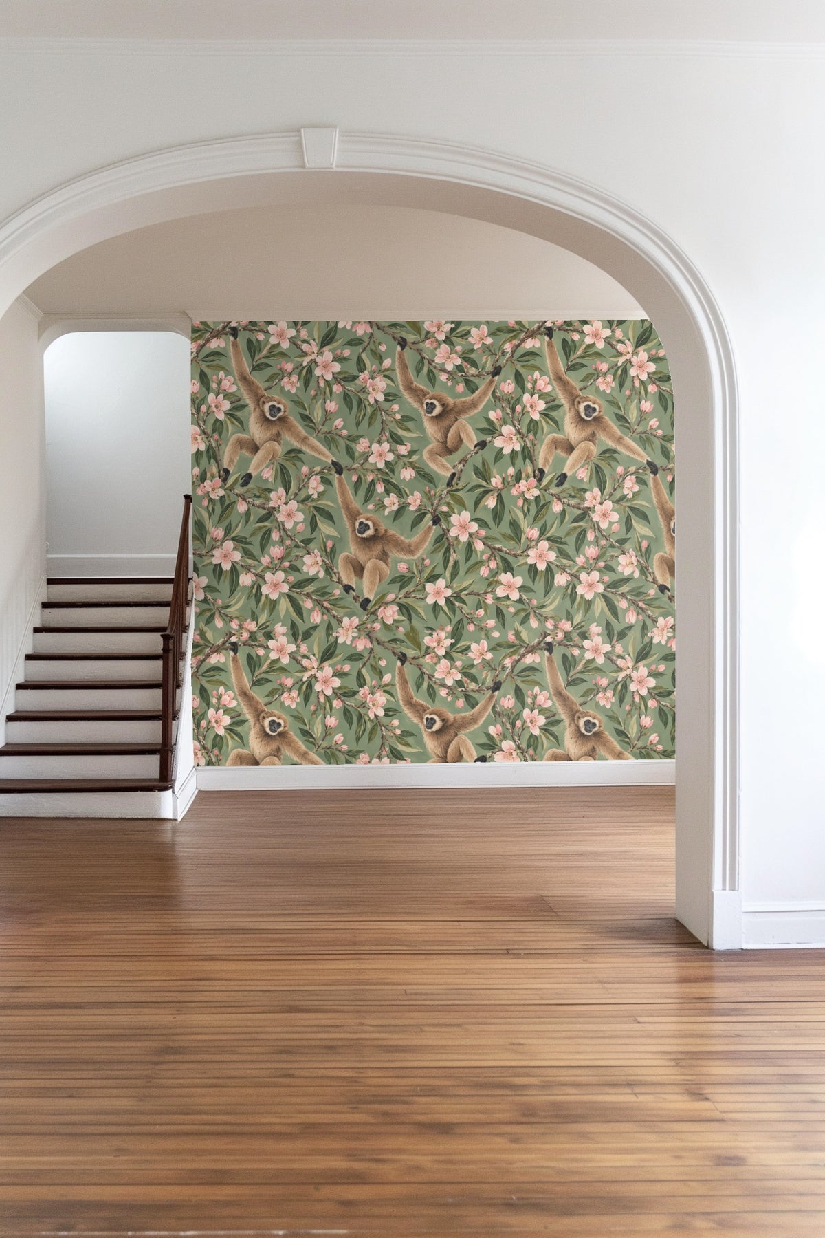 Bedroom with almond blossom gibbons wallpaper behind an olive green bed and floor mirror