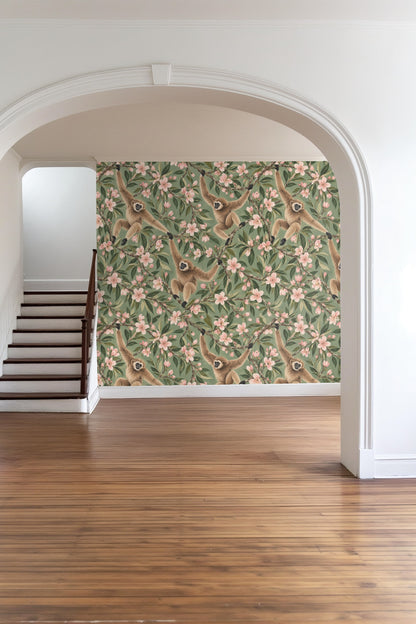 Bedroom with almond blossom gibbons wallpaper behind an olive green bed and floor mirror