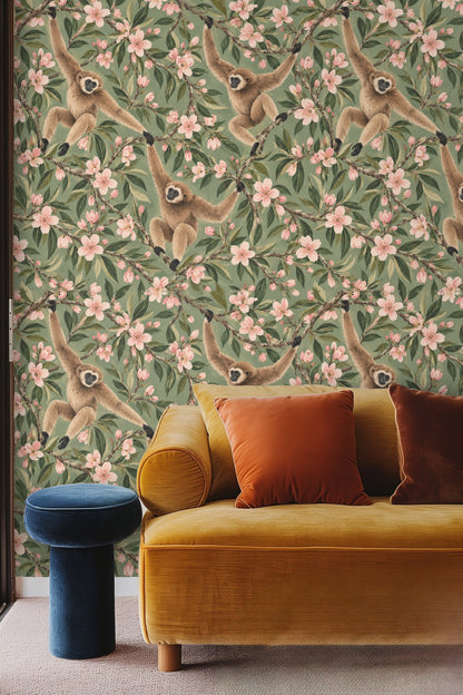 Pattern showing repeated motifs of three gibbons sitting and climbing almond blossom branches
