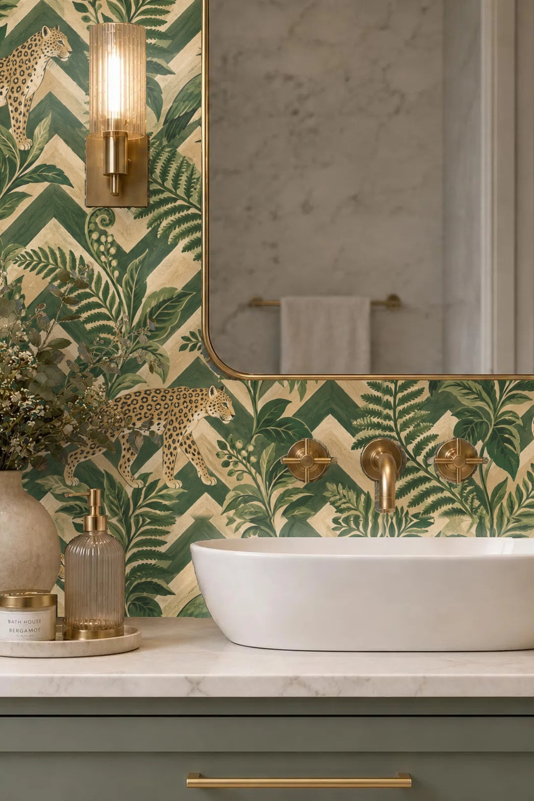 Interior entryway wall with zigzag fern and leopard wallpaper behind beige wooden console and white framed artwork.