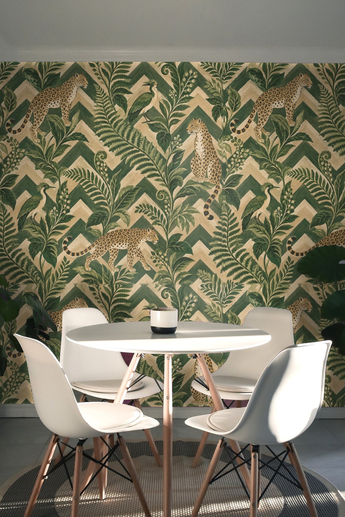 Entryway vignette highlighting the vibrant wallpaper with textured wood console and minimal decor.