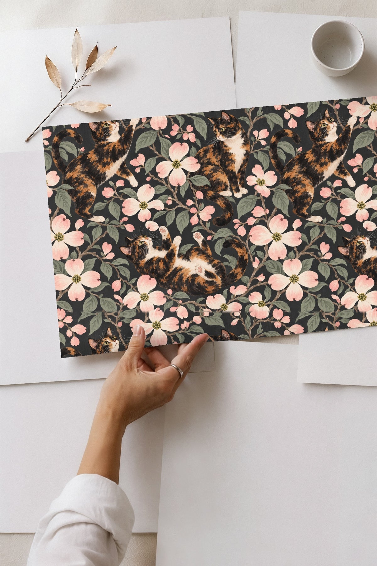 Artwork showing detailed brush strokes of calico cat fur and dogwood flower petals.