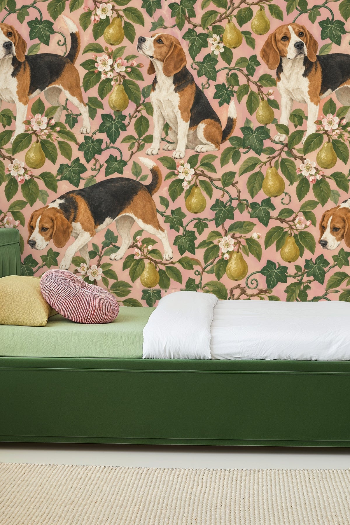 Interior view showing wallpaper with playful dog and pear motif behind mid-century modern orange sofa.