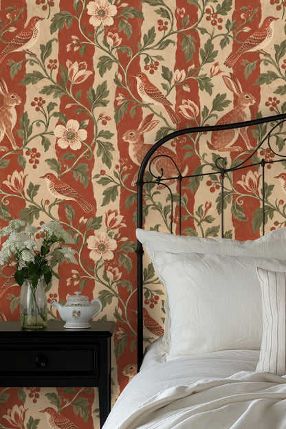 Living room scene with cream sofa and pillows against the wallpaper showing hares, birds, and floral vines on striped background