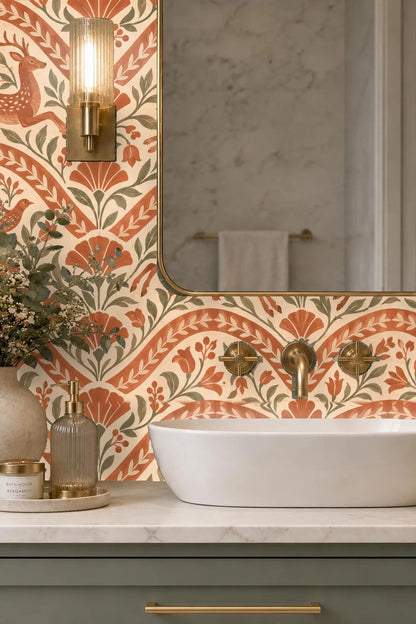 Close-up of terracotta wallpaper with hare and deer motifs behind a candle and white flowers on a side table