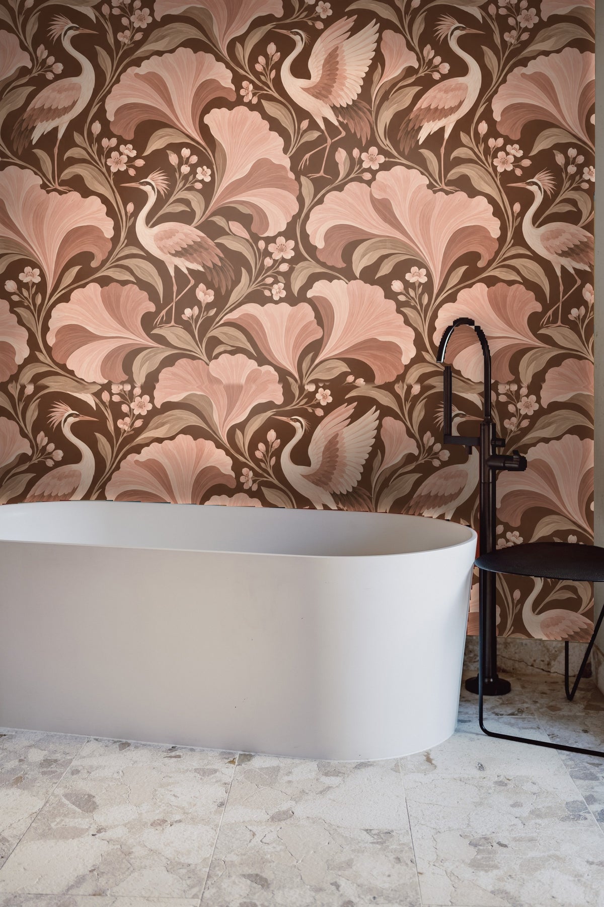 Wallpaper as backdrop behind a wooden bench with neutral pillow and throw in the entry alcove.