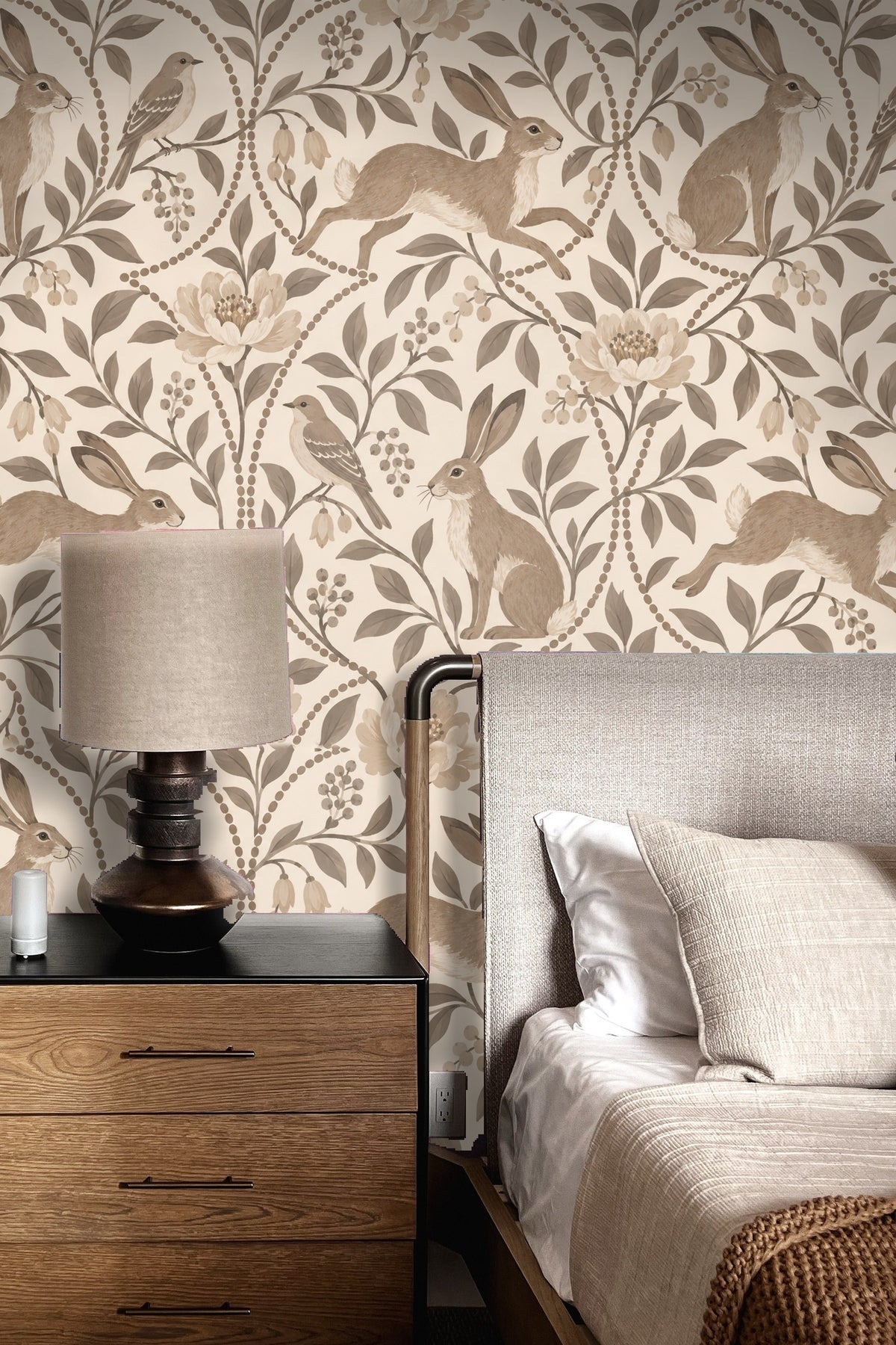 Living room wall with the wallpaper in soft taupe and cream, paired with cream pillows on a beige sofa