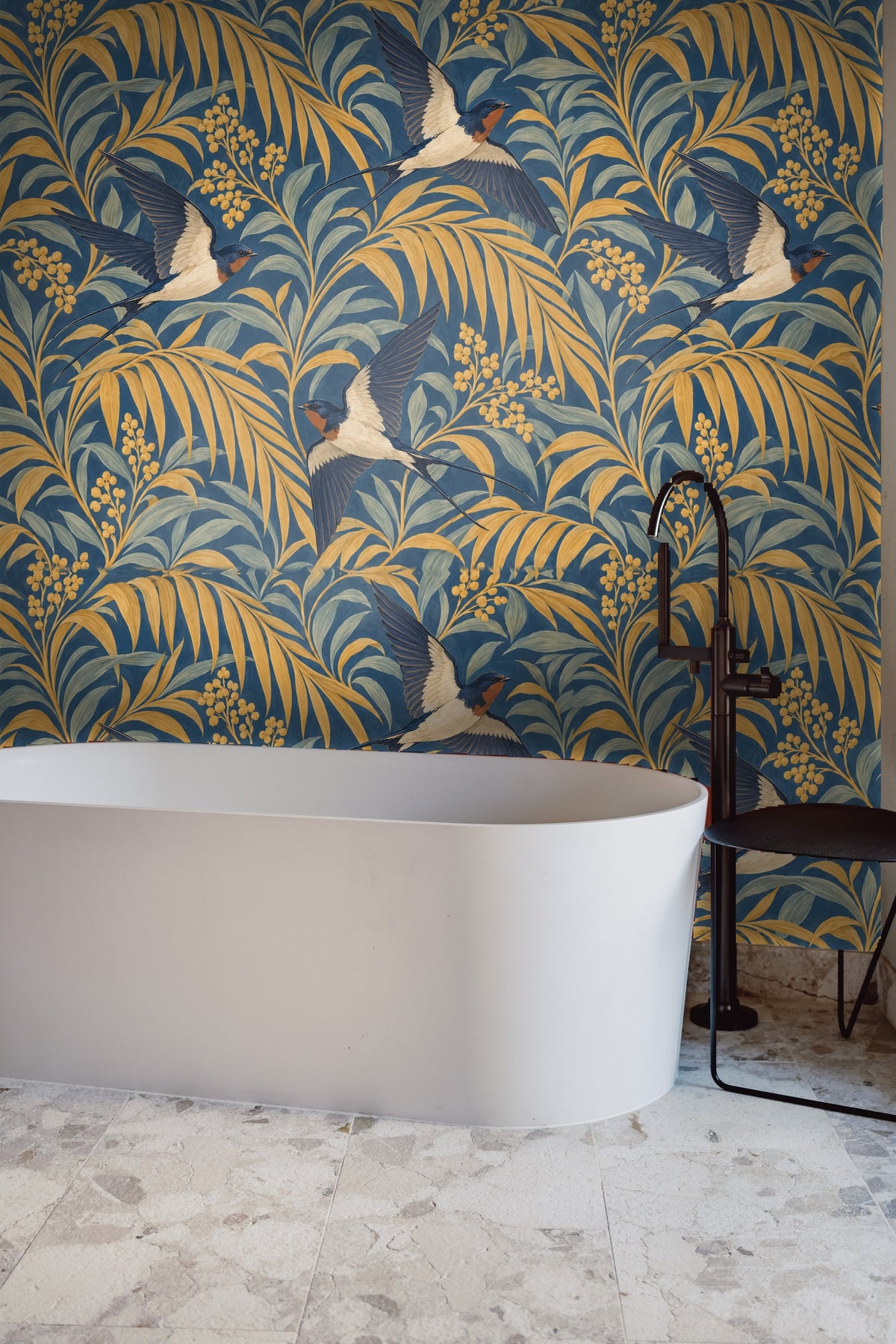 Pattern repeat of flying swallows amidst golden palm fronds and muted green leaves