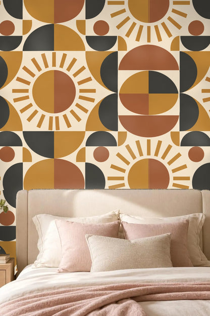 Bedroom with bed and pink pillows against Ochre Sundial wallpaper with geometric sunburst pattern