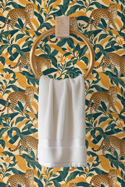 Close-up detail of amber leopard fur and teal leaves in wallpaper