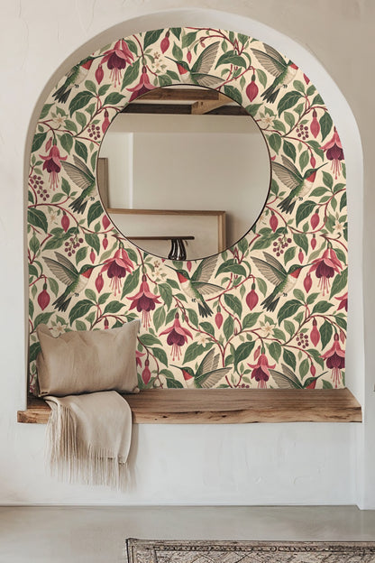Entryway wall with Nectarwing Fuchsia wallpaper framing a round mirror over a wooden bench with beige throw.