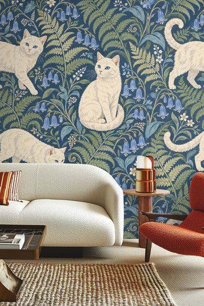 Bedroom with a green bedframe and Blue Fern Catwalk wallpaper behind it
