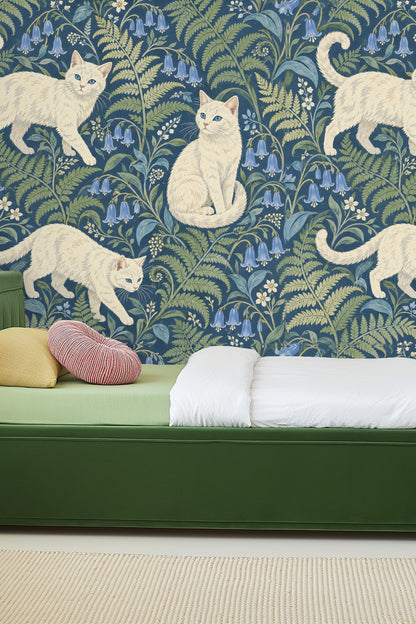Wallpaper featuring white cats and bluebell flowers with green ferns on a navy blue background