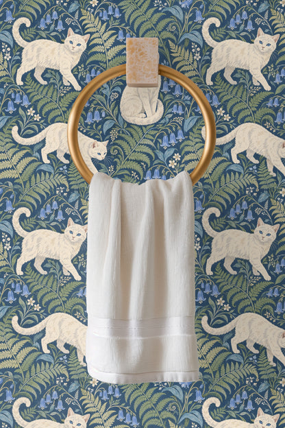 Multiple white cats walking and sitting among bluebells and ferns on wallpaper