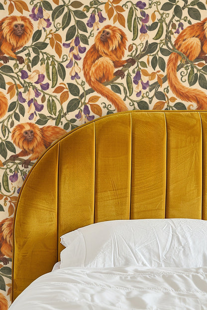 Wallpaper pattern with orange golden tamarin monkeys and green leaves
