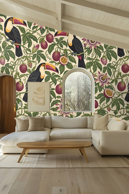 Bedroom wall featuring Passionfruit Toucan Loop wallpaper behind a peach-colored headboard with white and orange pillows