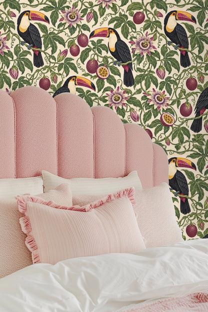Pattern repeat showing passionfruit fruits and green leaves around a toucan