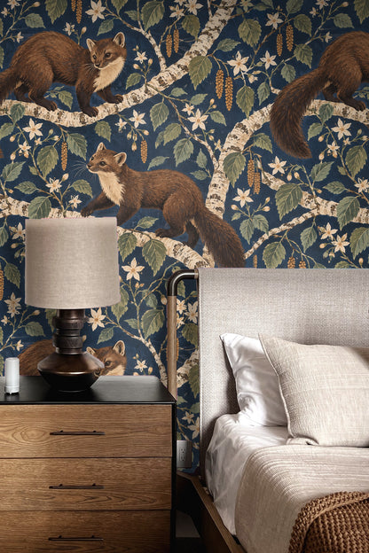 Atmospheric view of a blue floral and animal wallpaper in a modern living room with mid-century furniture and warm-toned carpet.