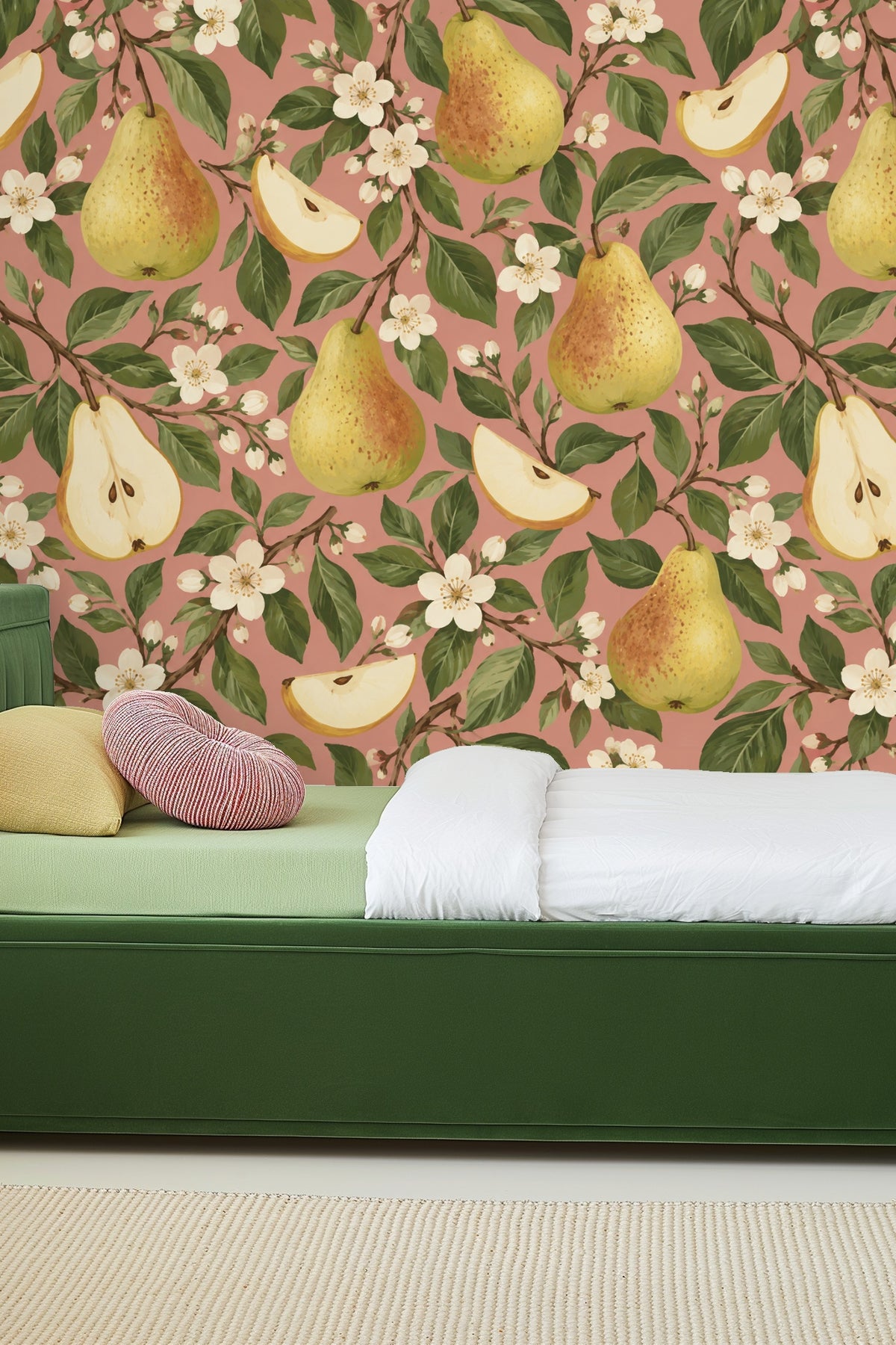 Mid-century modern chair near pear-themed wallpapered wall.
