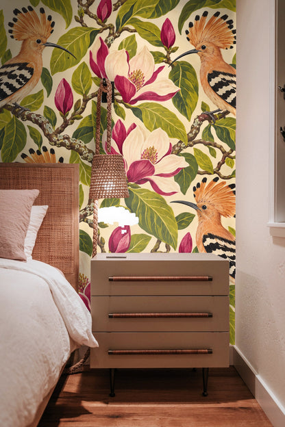 Side view of squiggly magnolia branches and leaves interwoven with birds in the naturalistic wallpaper design.